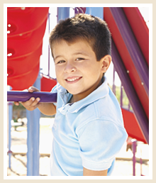 Smiling male student on a playground